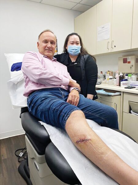 Peter Graylin and his surgeon, Jane Yoo, MD, at Dr. Yoo’s office for suture removal