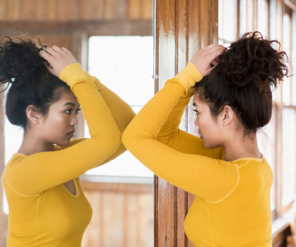 The Big See Skin Cancer Foundation Young woman looking at herself with a tall mirror